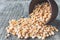 Dry yellow peas in a bowl on old boards. Chipped yellow peas are used for cooking