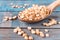 Dry yellow peas in a wooden spoon on old boards. Chipped yellow peas are used for cooking