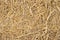 Dry yellow straw grass background texture closeup wallpaper.
