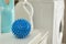 Dryer ball and laundry detergents on white table indoors, closeup