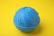 Dryer ball for washing machine on yellow background. Laundry detergent substitute