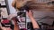 Drying blond hair with hair dryer and round brush at hairdresser. Vertical 4K.