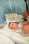 Drying of the child after a bath. bathing newborn. Cute newborn girl, a boy in a towel after a bath with his mother`s hands dryly