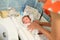Drying of the child after a bath. bathing newborn. Cute newborn girl, a boy in a towel after a bath with his mother`s hands dryly