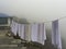 Drying white cloth in the mist, mountain village