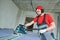 Drywall construction at home. Contractor worker milling gypsum plasterboard by hand-held router machine