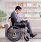 Dsabled businessman on wheelchair working home