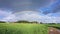 Dual rainbow over a village