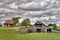 Dual Wooden Barns Under a Cloudy Sky