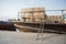 Dubai Creek dhow boat moored about to unload different goods on the pier, United Arab Emirates