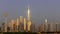 Dubai Downtown skyline landscape with the skyscrapers reflecting golden sun during sunrise.