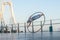 Dubai, February 2020. Cyr Wheel artist with Ferris wheel on background of Dubai during sunset