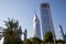 Dubai financial district, modern twin skyscrapers and palm trees in a sunny day