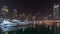 Dubai marina bay with yachts an boats night