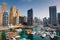 Dubai marina with boats and buildings with gates