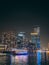 Dubai Marina, harbour, cruise boat and canal promenade view at night, in Dubai, United Arab Emirates