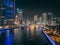 Dubai Marina, harbour, cruise boat and canal promenade view at night, in Dubai, United Arab Emirates