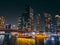 Dubai Marina, harbour, cruise boat and canal promenade view at night, in Dubai, United Arab Emirates