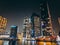 Dubai Marina, harbour, cruise boat and canal promenade view at night, in Dubai, United Arab Emirates