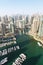 Dubai Marina and Harbour luxury wealth travel with boats yacht in United Arab Emirates from above portrait format