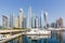 Dubai Marina and Harbour skyline architecture wealth luxury travel in United Arab Emirates with boat yacht