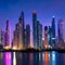 Dubai marina skyline at night with water reflections