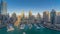 Dubai Marina skyscrapers aeral timelapse, port with luxury yachts and marina promenade