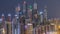 Dubai marina with traffic on sheikh zayed road panorama day to night timelapse lights turn on.