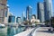 Dubai Marina Yacht Club along walkway with speed and pleasure boats and mosque in the futuristic skyline and harbour near