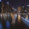 Dubai Marina Yacht Club long exposure square crop at night with lights of skyline and creek for luxury vacation and travel