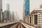 Dubai metro railroad at new futuristic skyscrapers buildings skyline background