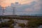 Dubai& x27;s skyline from the side of the highway with power towers at the sunset