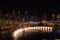 Dubai singing fountains at night lake view between skyscrapers. City skyline in dusk modern architecture in UAE capital