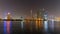 Dubai skyline at night with lights on the water and luxirious skyscrapers of UAE