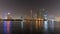 Dubai skyline at night with lights on the water and luxirious skyscrapers of UAE