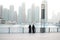 Dubai - skyline at sunrise of Dubai business center, two women in United Arab Emirates