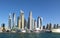 Dubai skyline, UAE. Luxury residential district in Dubai. Generic Modified Luxury Yacht with Skyscrapers background. Stunning Duba