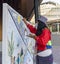 Dubai, UAE - 10.15.2021 indigenous peruvian woman painting in traditional style at EXPO 2020, Peru pavilion , Event