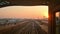 Dubai, UAE - 10th october, 2022: metro train on railway arrive to station in Dubai city with sunset orange sky background