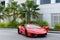 DUBAI, UAE - JANUARY 13, 2017: Red luxury supercar Lamborghini Aventador Roadster car on the road in Dubai