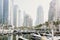 Dubai; UAE - June 6, 2020: Dubai Marina promenade with residential buildings, offices, hotels, yachts and boats early in the morni