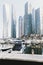 Dubai; UAE - June 6, 2020: Dubai Marina promenade with skyscrapers and luxury yachts and boats early in the morning