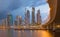 DUBAI, UAE - MARCH 24, 2017: The evening skyline with the bridge over the new Canal and Downtown with ths storm clouds