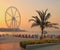 Dubai, UAE - May 08, 2018: Dubai Marina promenade at sunset. Ferris wheel, Dubai marina beach, United Arab Emirates.  Marina beach