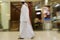Dubai UAE Two men traditionally dressed in dishdashs and gutras white robes and headdresses.