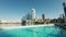 Dubai - United Arab Emirates, January 23, 2023: Hotels of Dubai city. Action. Blue cear water of the city fountain.
