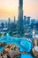 Dubai, United Arab Emirates - July 5, 2019: Burj khalifa rising above Dubai mall and fountain surrounded by modern buildings top