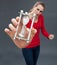 Dubious beautiful young woman holding an hour glass against stress