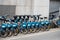 Dublin city center, Ireland - 07.06.2021: Row of blue color bicycle for rent by Now company. Transportation industry and a measure