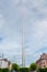 Dublin city center, Ireland - 07.06.2021: The Spiro monument on O`Connell street, Vertical image. Cloudy sky